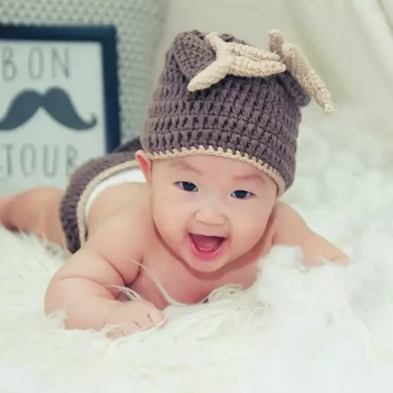 A baby with a knit hat